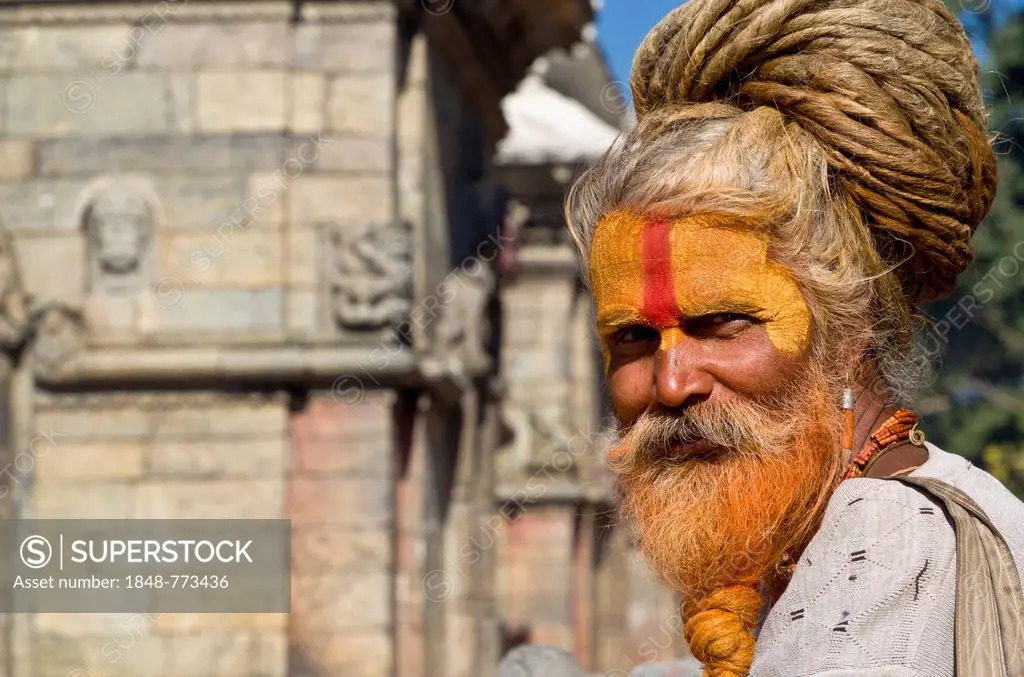 Portrait of a Sadhu, Holy Man, sitting opposite the burning ghats