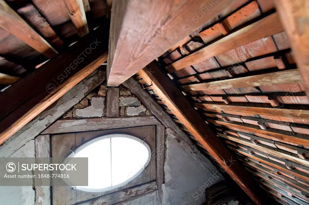 An oval window, wooden beams, attic, wooden roof of an old building, Stuttgart, Baden-Wuerttemberg, Germany, Europe