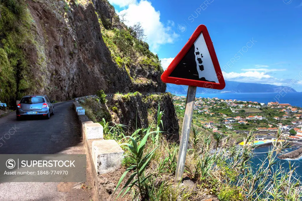 Warning sign, falling rocks, on road along the cliffs at Ponta Delgada