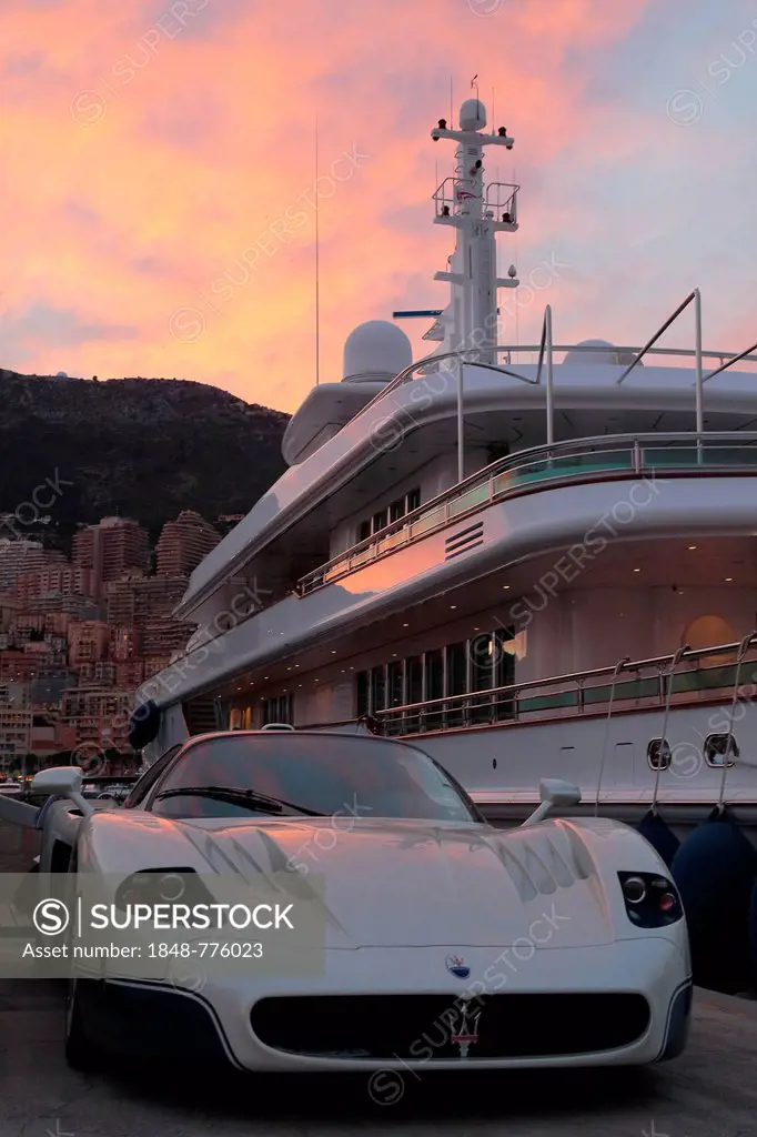 Maserati in front of the motoryacht Siran in Port Hercule at twilight