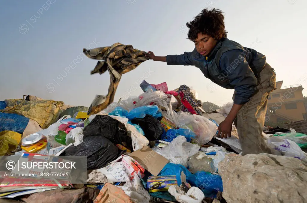 One of the children who live, play and work on the garbage dump at Bhagmati River in the middle of the city