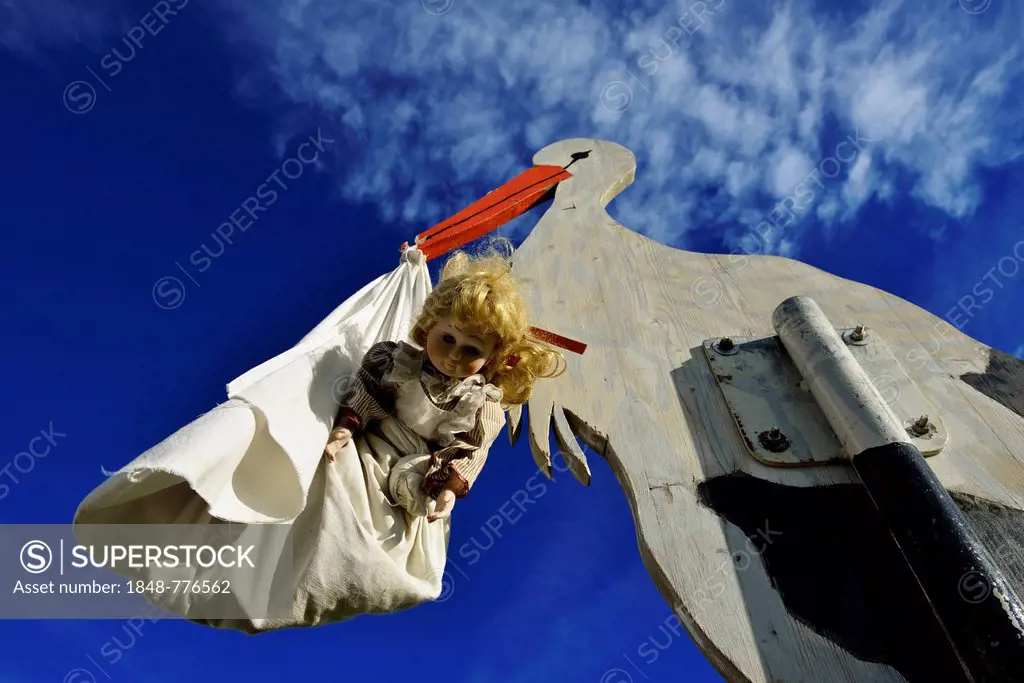 Stork bringing a baby, wooden figure, Tannberg Mountain, Koestendorf, Lake Waller, Salzburg Lakes District, Salzburg, Austria, Europe