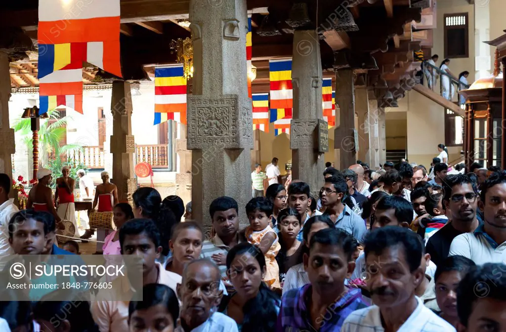 Believers are queuing at the Buddhist shrine, Sri Dalada Maligawa, Temple of the Tooth in Kandy