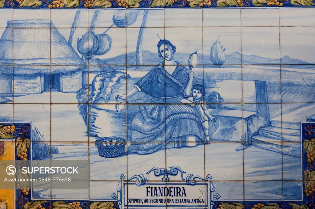 Azulejo, mural made of ceramic tiles, woman holding a spindle, in Funchal