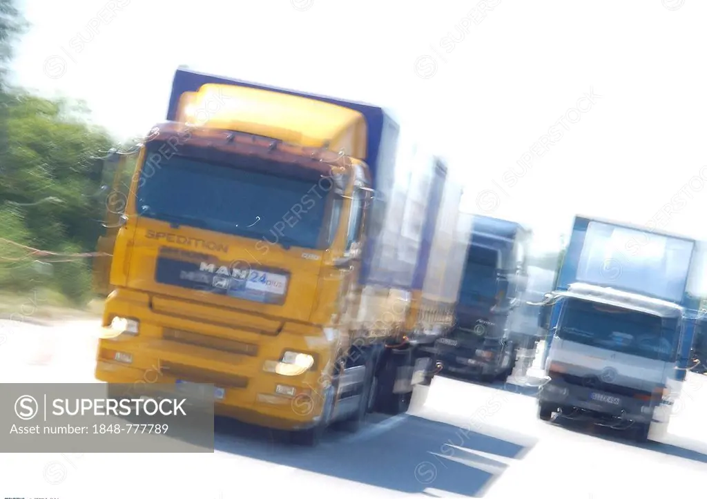 Trucks with motion blur on a road