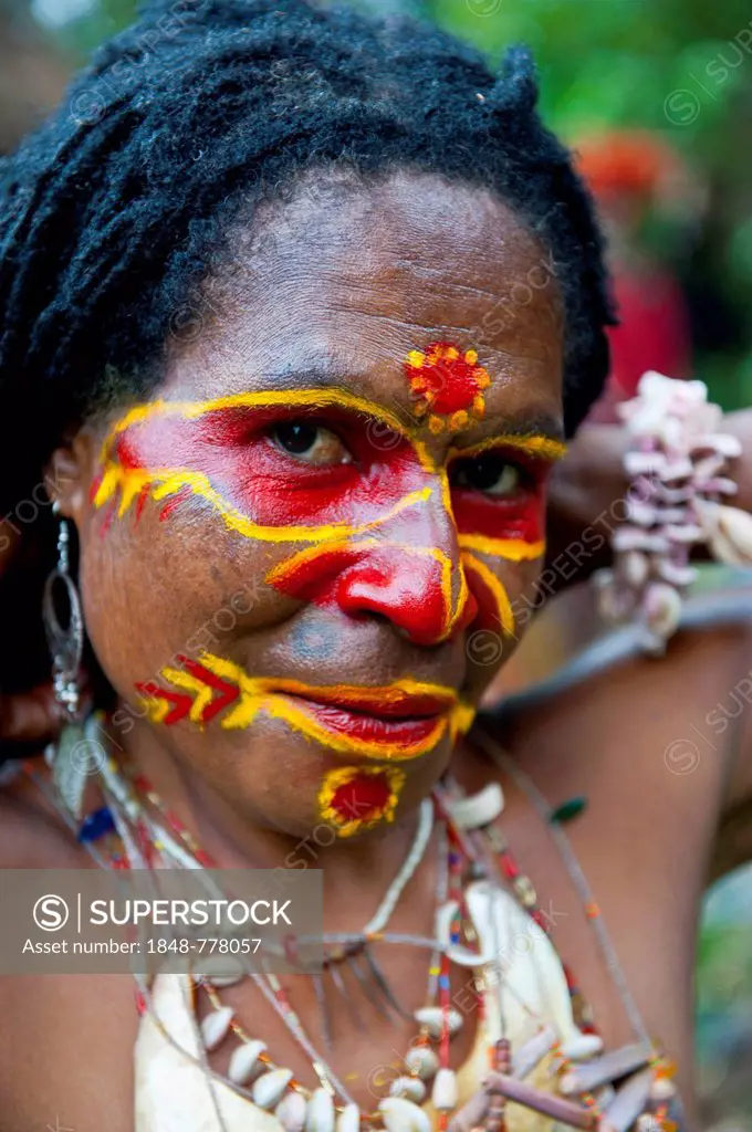 Woman with colourful face paint is celebrating at the traditional Sing Sing gathering in the highlands