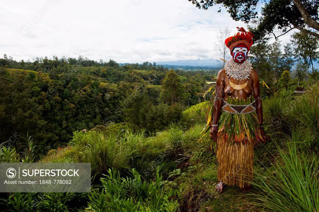 Woman with a colourfully decorated costume and face paint is celebrating at the traditional Sing Sing gathering in the highlands