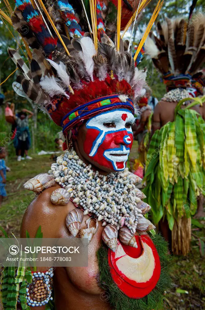 Woman with a colourfully decorated costume and face paint is celebrating at the traditional Sing Sing gathering in the highlands