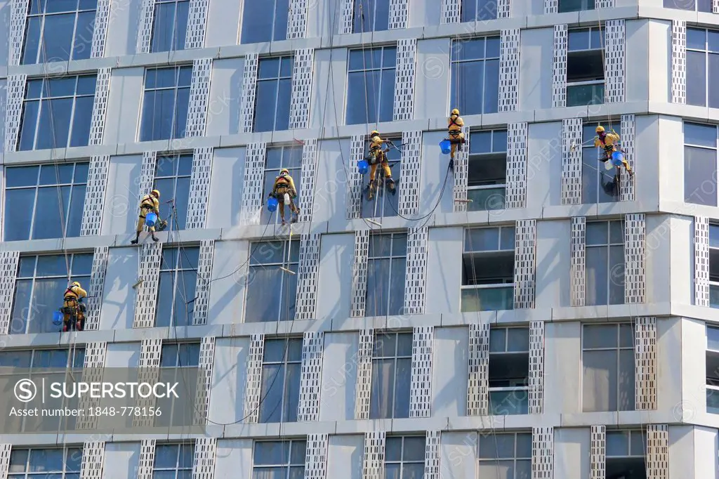 Window cleaners working on the façade of a skyscraper