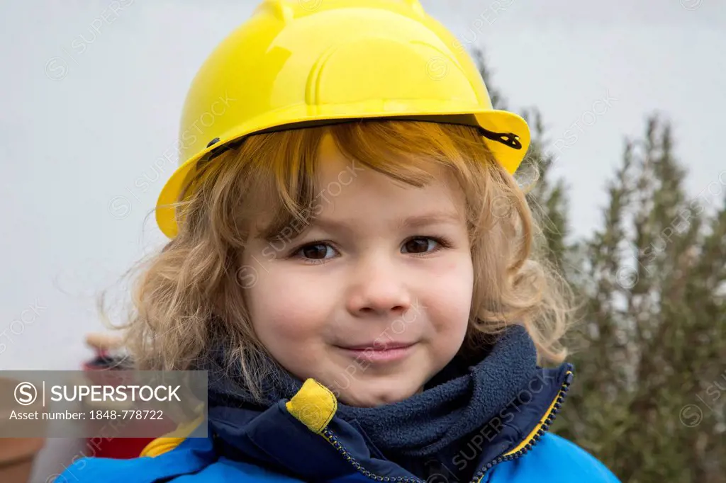 Little boy, 3 years, with toy hard hat