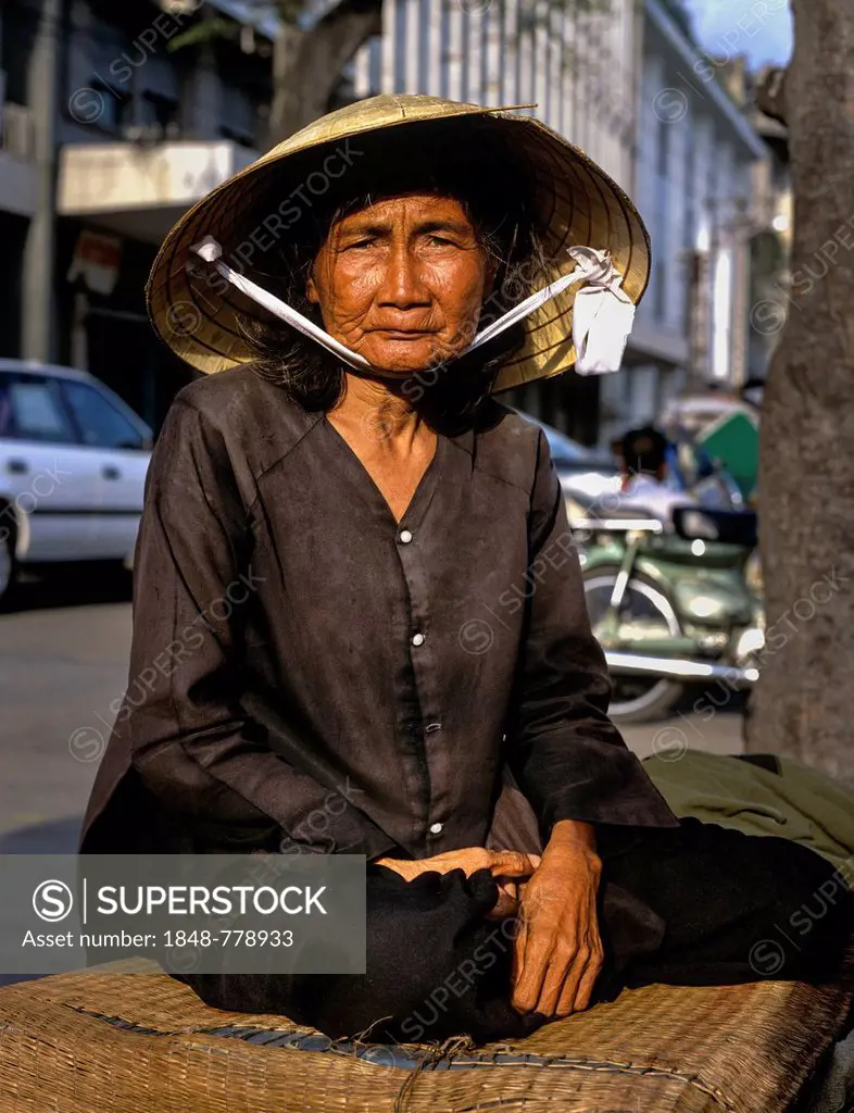Elderly Vietnamese woman with a conical hat or Non La, portrait
