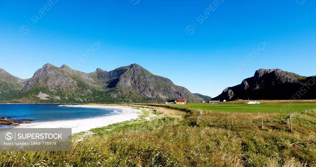 White sandy beach on the North Atlantic, bay with green meadows