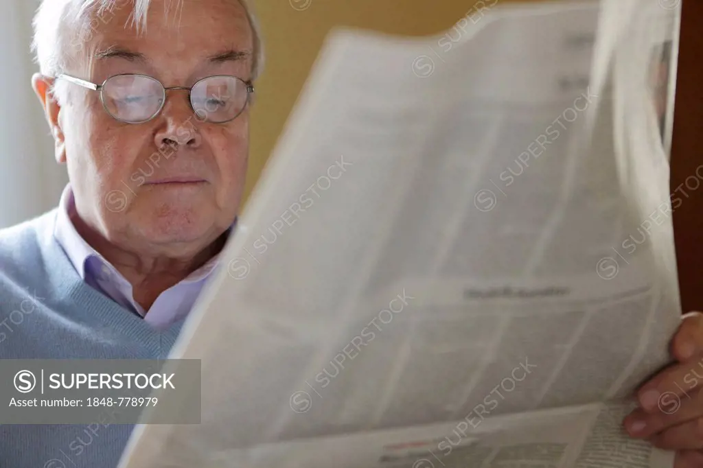 Senior citizen reading a newspaper