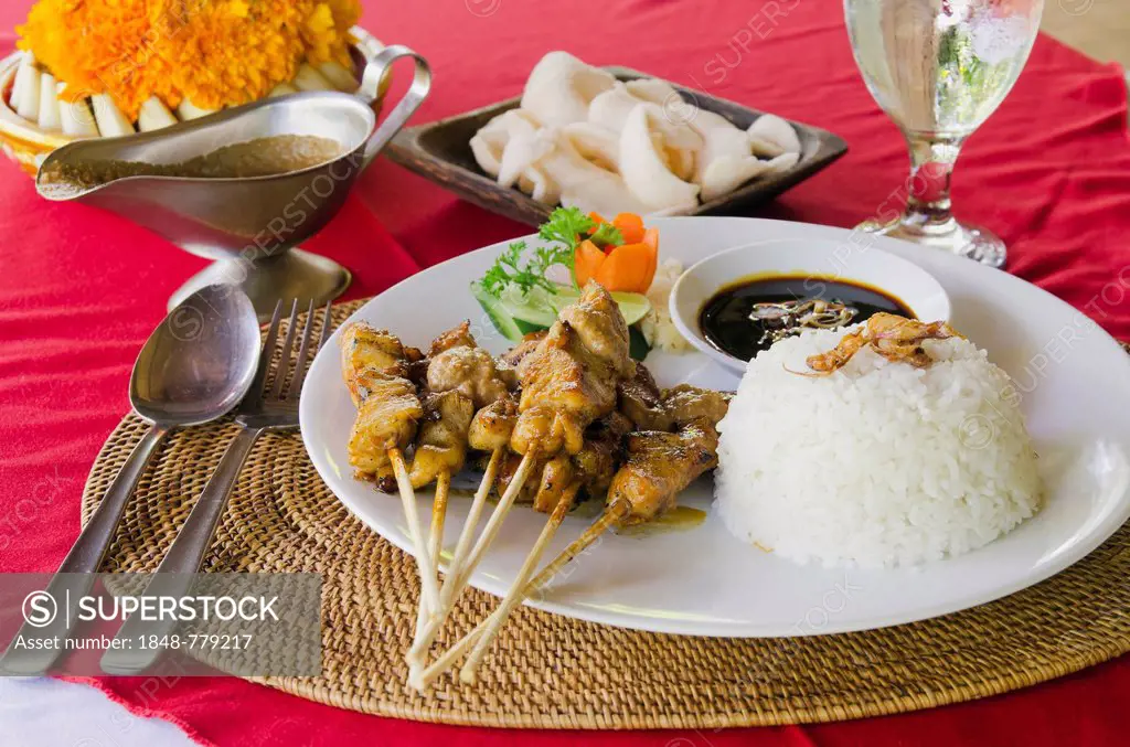 Chicken satay, chicken skewers with rice, Indonesian cuisine, at a restaurant