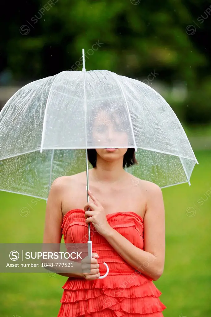 Woman with umbrella outside in a summer rain