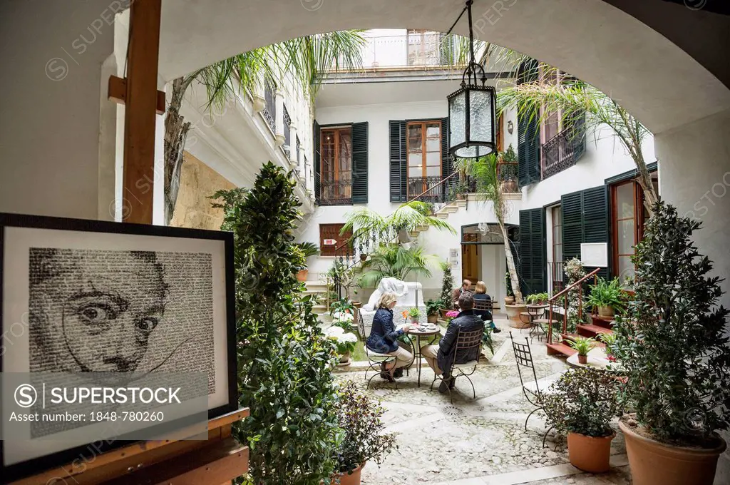 Courtyard with a café, portrait of Salvador Dali at front, Dali Museum
