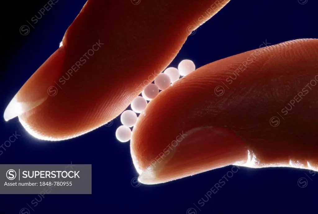 Globules held between fingers, with backlighting