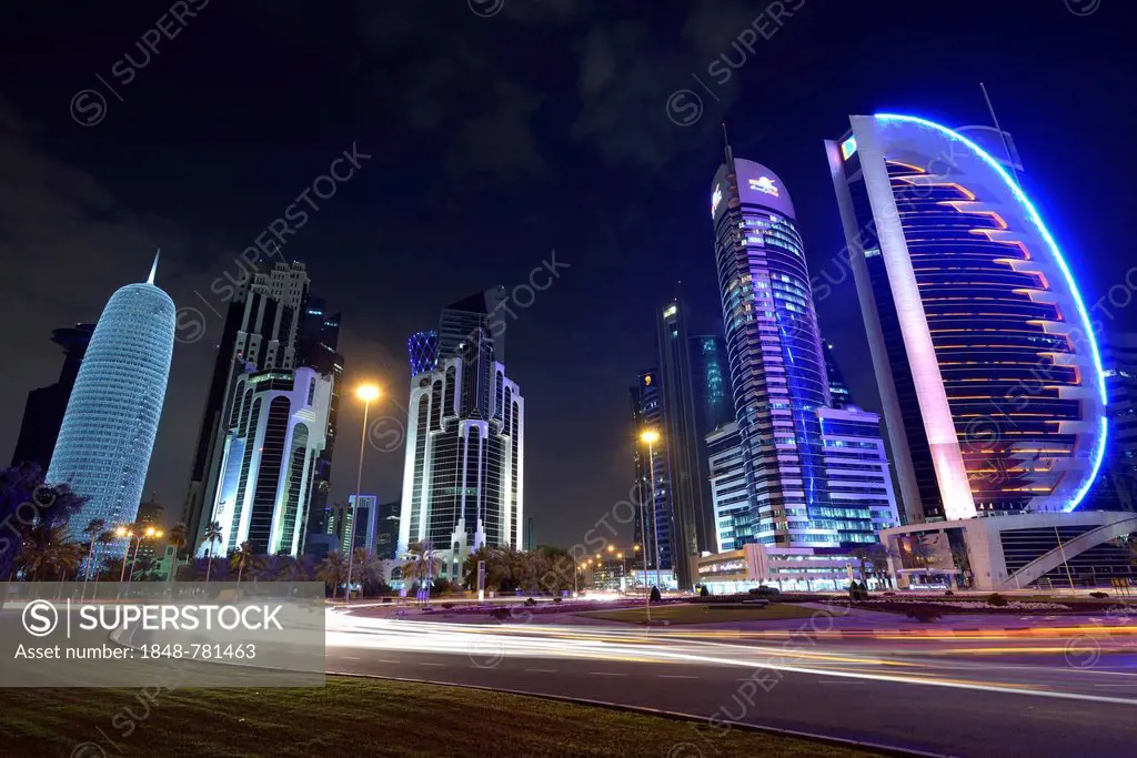 Skyline of Doha at night with Palm Tower 1 and 2, the World Trade Center, Tornado Tower, Burj Qatar Tower with silver illumination, Kahra Maa Tower an...