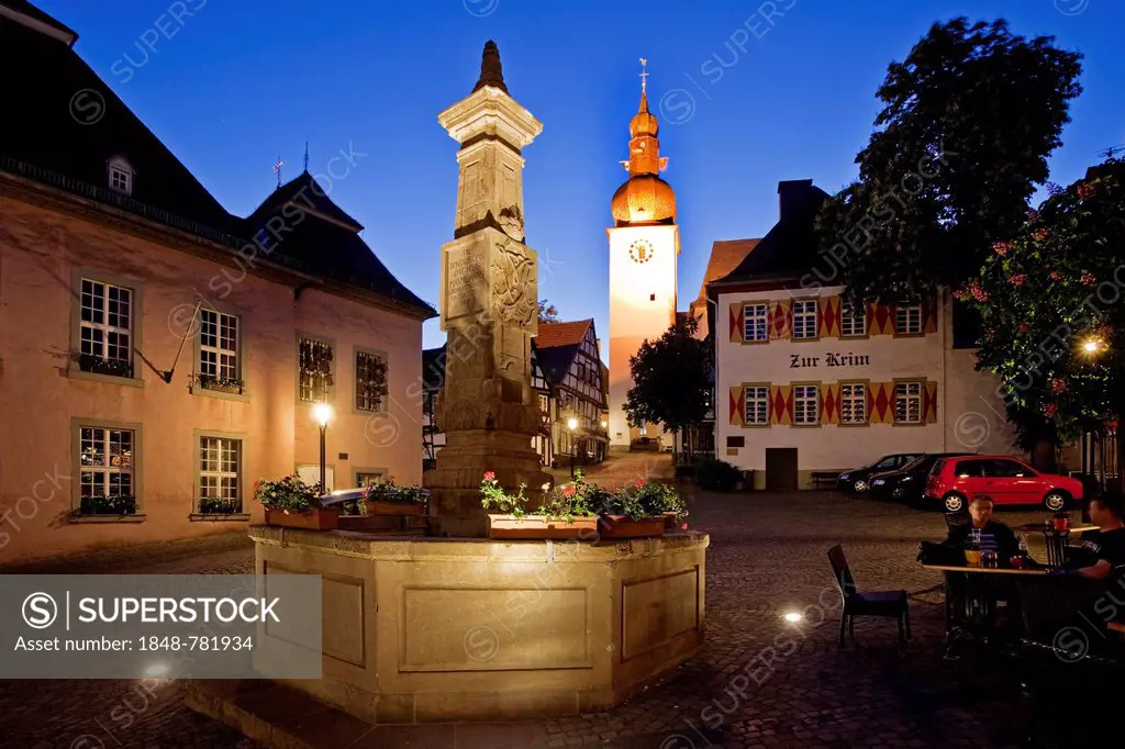Maximilian Fountain in Alter Markt square with the old town hall and the bell tower at dusk
