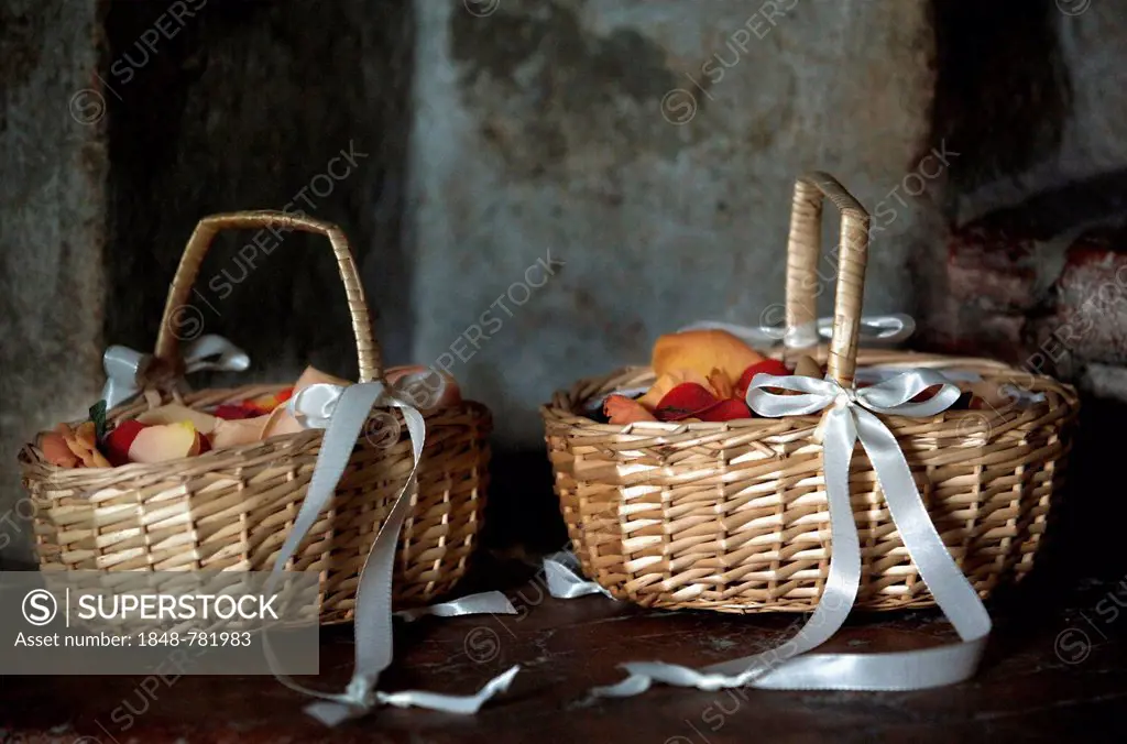 Two wicker baskets with rose petals