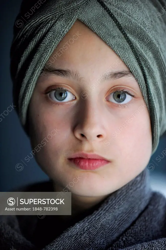 Young girl, 10, after a bath wearing a towel turban