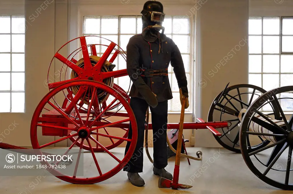 Firefighter wearing a breathing protection mask in front of a hose reel, early 20th century, exhibition of 150 years of Lauf Fire Department, Lauf Ind...