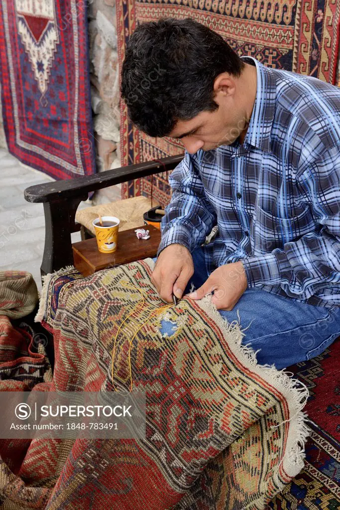 Man repairing a used carpet