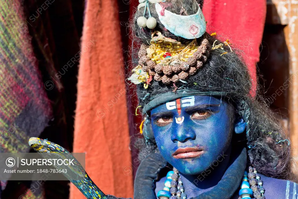 Indian boy, about 11 years, transformed with blue makeup into the Hindu God Shiva at a Hindu festival