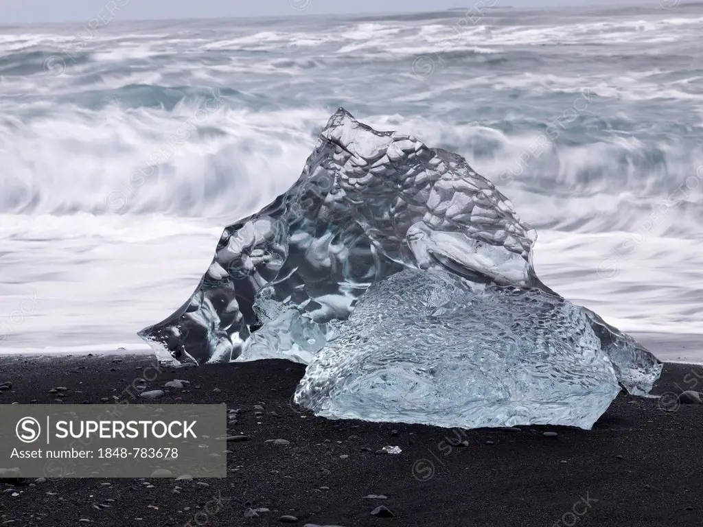 Chunk of ice lying on the black sandy lava beach on the edge of the Vatnajökull Glacier