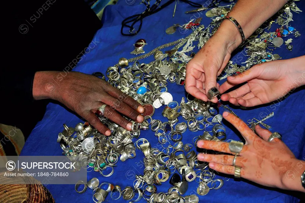 Female hands touching silver Berber jewellery, souvenir shop