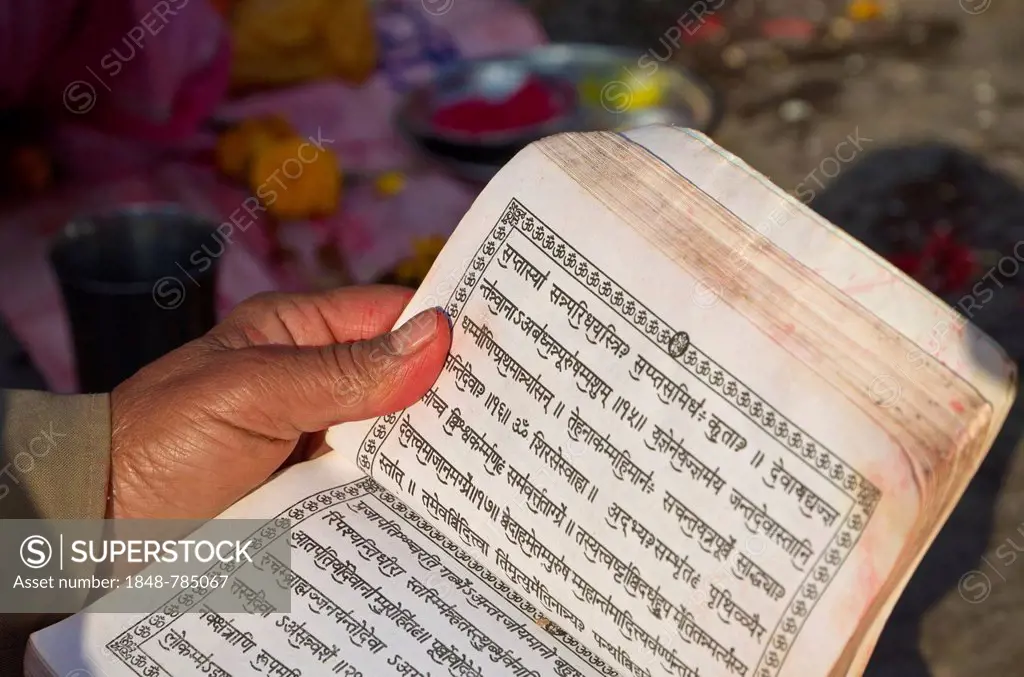 Devotee reading in the holy scriptures, written in Hindi characters