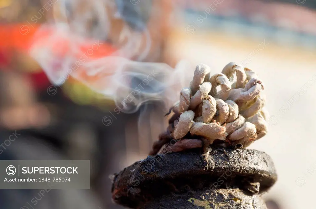 Incense burning in front of a Ganesha shrine