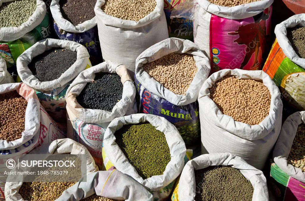 Many different types of dried pulses, dhal, in bags, displayed for sale