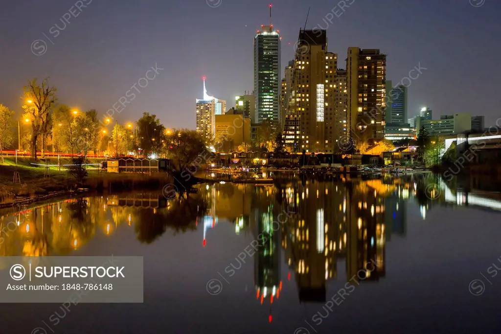 Donau City Vienna reflected in the Old Danube River, at night