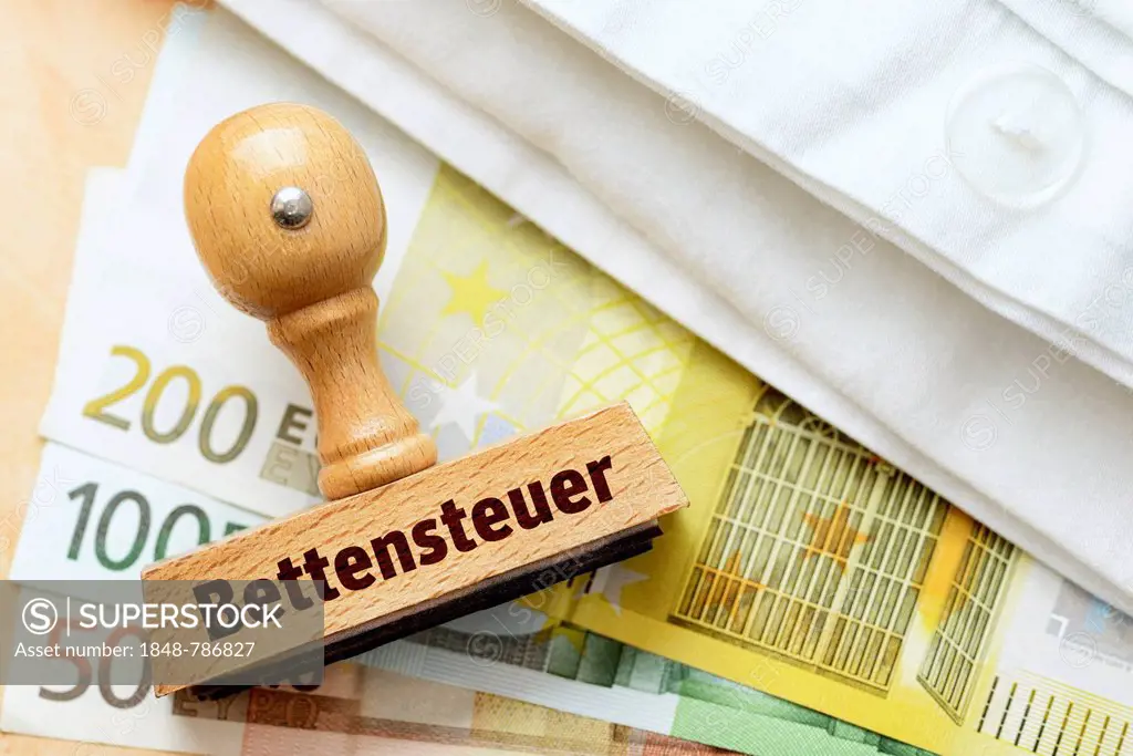 Stamp with the term Bettensteuer, German for bed tax on euro banknotes and a bed sheet