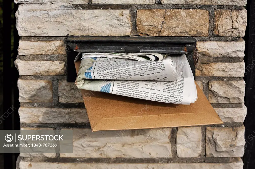 Full letter box of a house in a wall