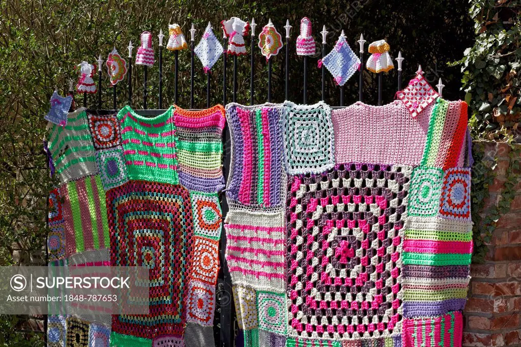 Knitted iron gate with Granny Square pattern, guerrilla knitting, knit art, graffiti knitting, street art