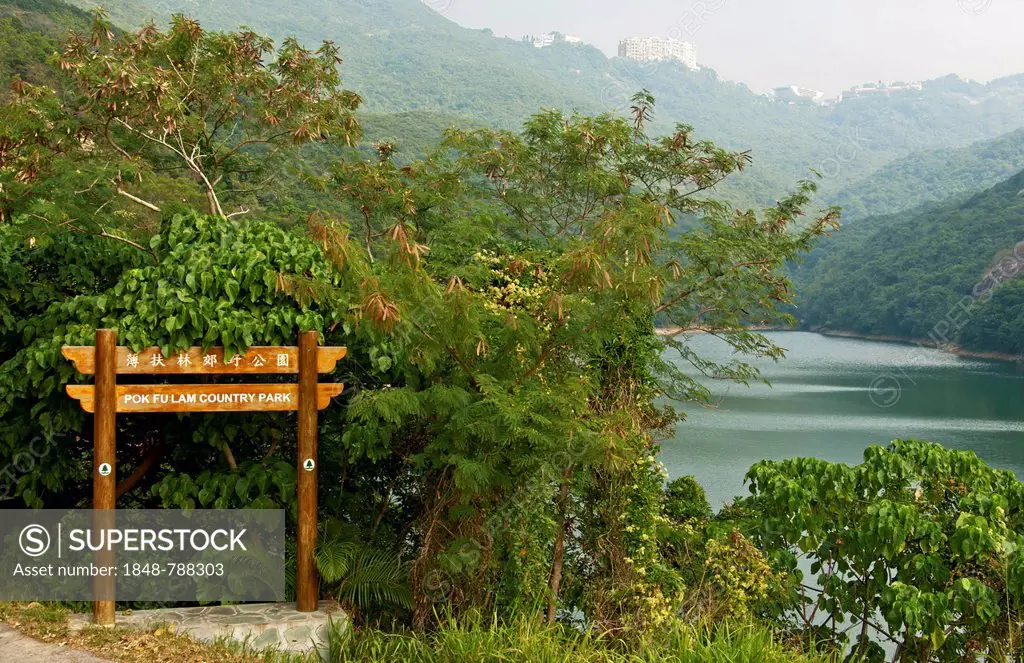 Signposts in Pok Fulam Country Park, the Pok Fu Lam Reservoir at back