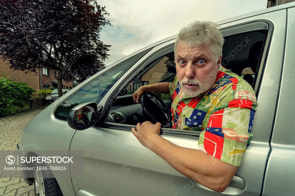 Car driver looking out of the car window angrily