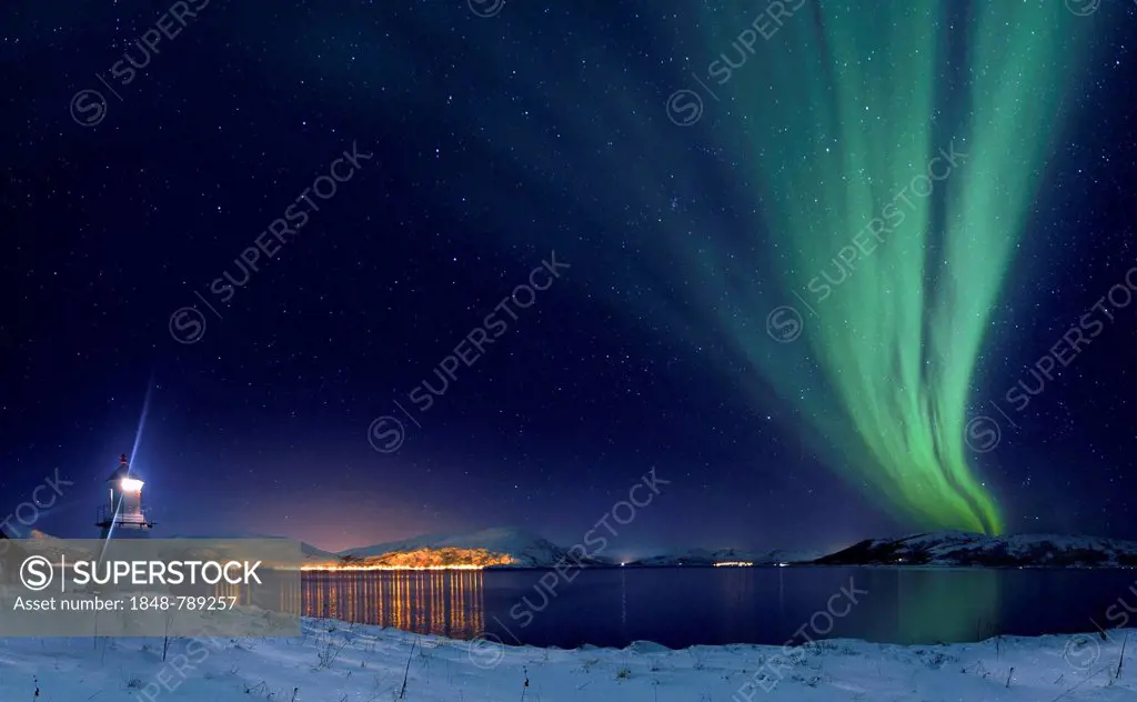 Aurora over fjord with lighthouse in winter