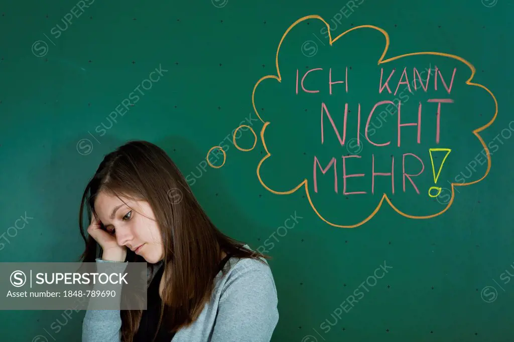 Depressed looking teacher standing in front of the blackboard with a speech bubble, Ich kann nicht mehr, German for I can't take anymore, symbolic ima...