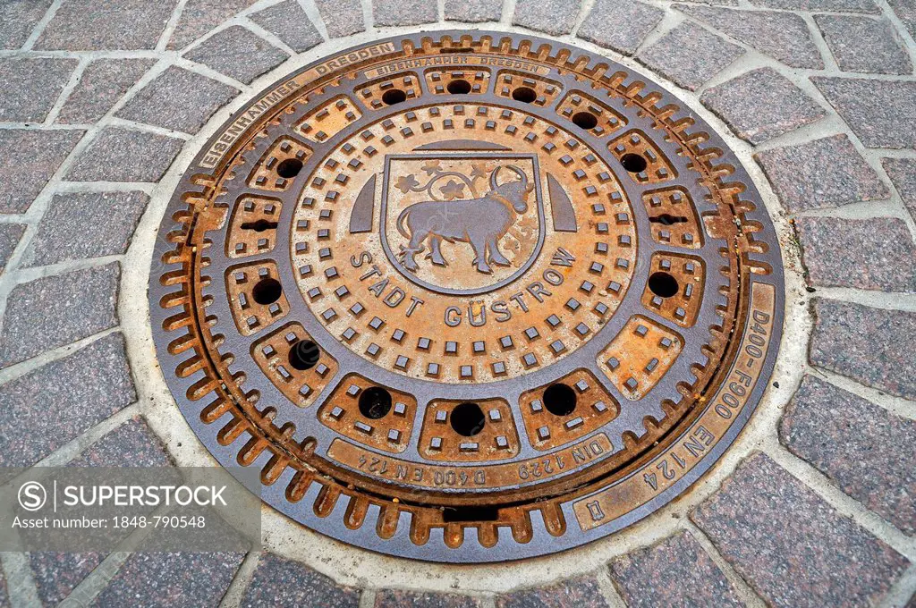 Manhole cover with the bull, coat of arms of the town of Guestrow