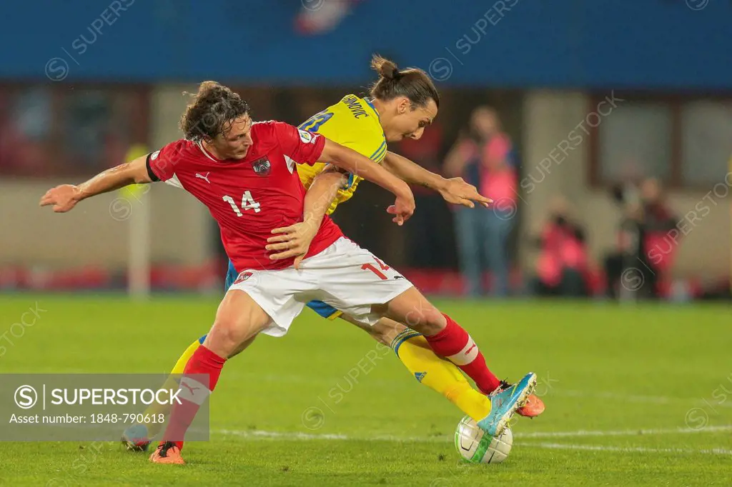Julian Baumgartlinger, No. 14 Austria, and Zlatan Ibrahimovic, No. 10 Sweden, fight for the ball during the world cup qualifier game on June 7, 2013 i...