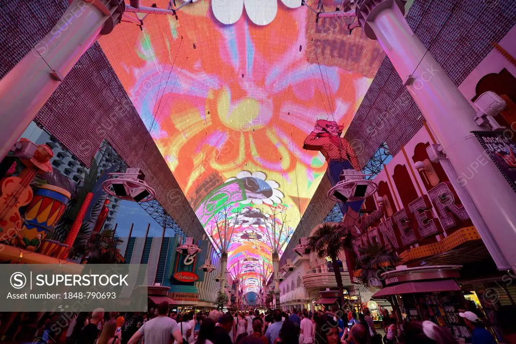 Tourists marvelling at the laser show in the neon dome of the Fremont Street Experience in old Las Vegas, downtown