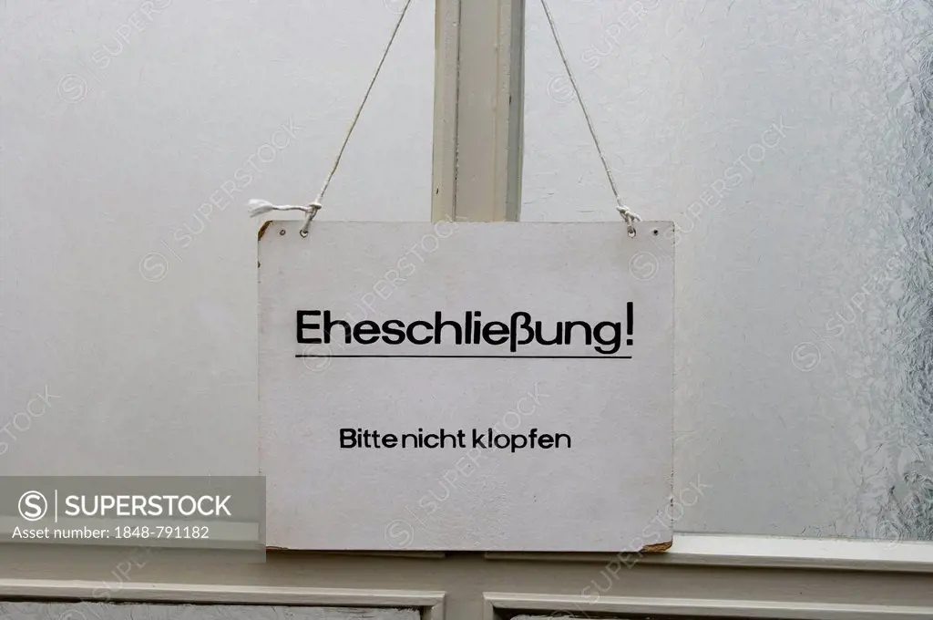 Sign on a door in the Falkensee registry office with the message, Eheschliessung, bitte nicht klopfen, German for marriage ceremony, please do not kno...