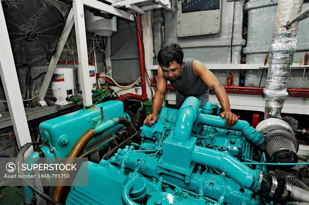 Machine operator in the engine room on the Buginese Schooner, Seven Seas Liveaboard