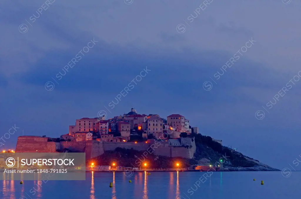 The citadel (castle) of Calvi surrounded by the mediterranean sea at the blue hour before sunrise. Calvi is in the department Haute-Corse, France on t...