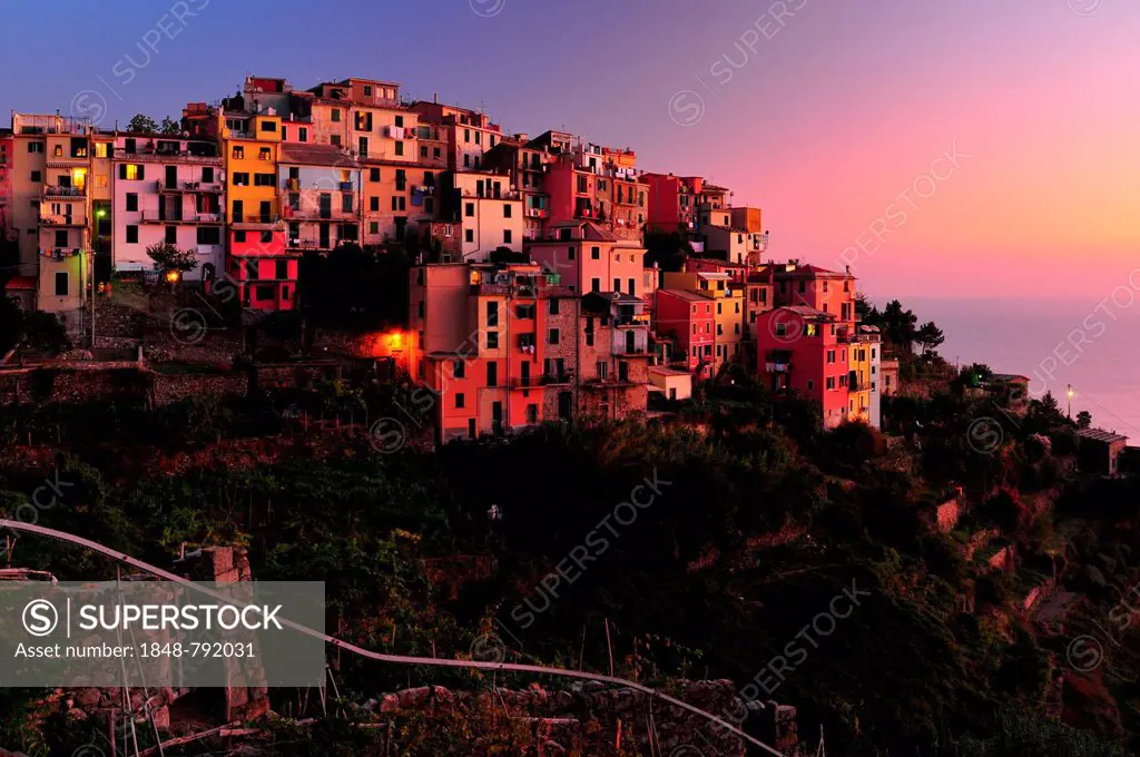 The village of Corniglia with vineyards in the evening light, the monorail in the foreground