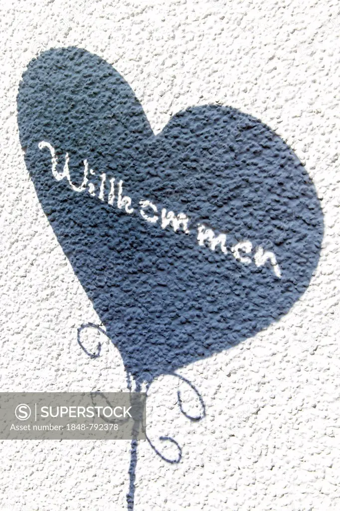 Heart with the word Willkommen, German for welcome, on a wall