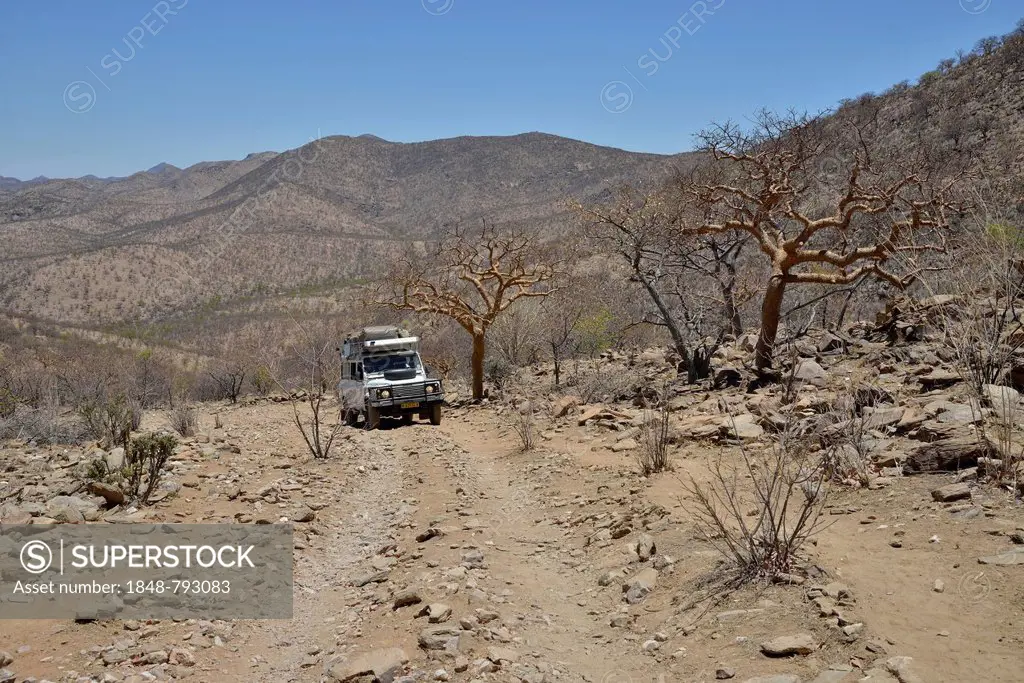 Safari vehicle driving along a mountain road, Otjihaa Pass